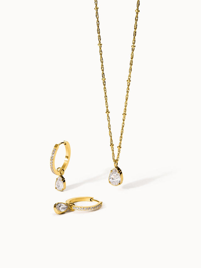Goldene Kette und Ohrringe mit klaren Steinen, elegant und feminin – PURELEI.