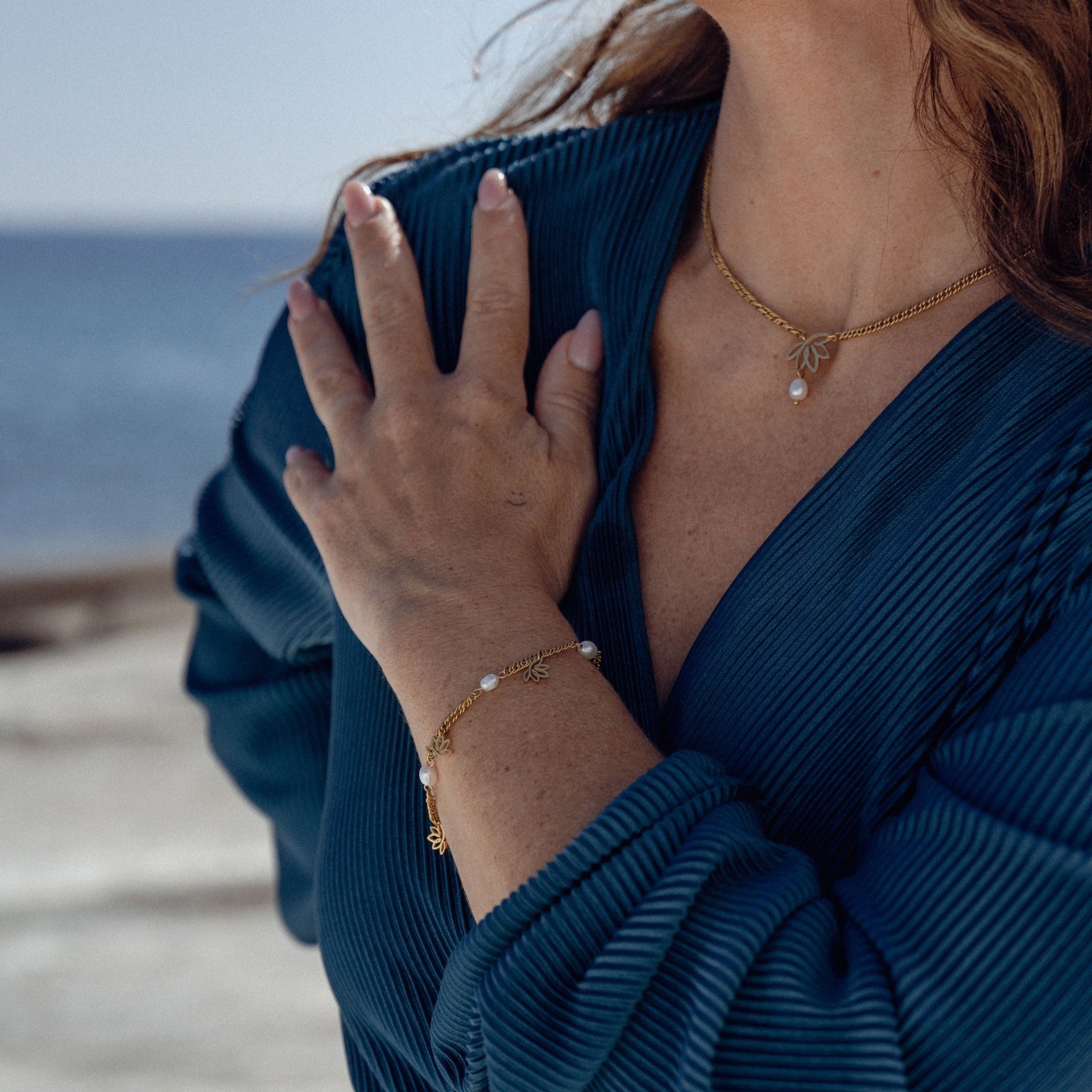 Roségoldene Kette und Armband mit Perlen, getragen am Handgelenk, PURELEI Stil.