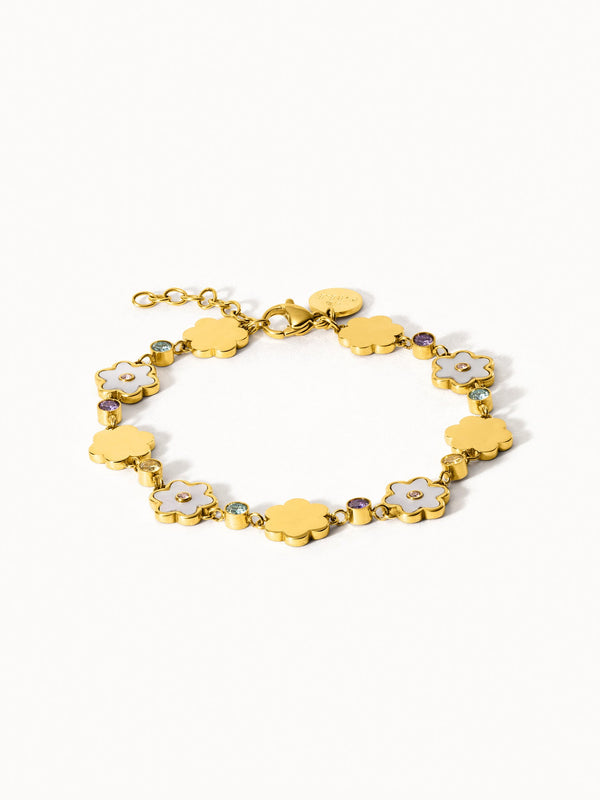 Goldenes Armband mit blütenförmigen Anhängern und funkelnden Details von PURELEI.
