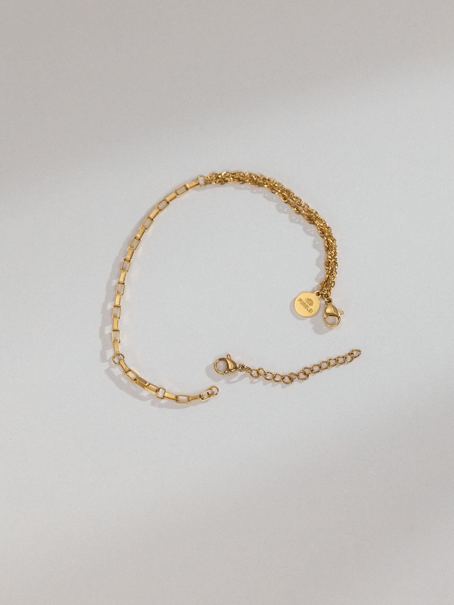 PURELEI Armband Extender in 18K Gold mit feiner Gliederkette auf hellem Hintergrund, elegant und zeitlos