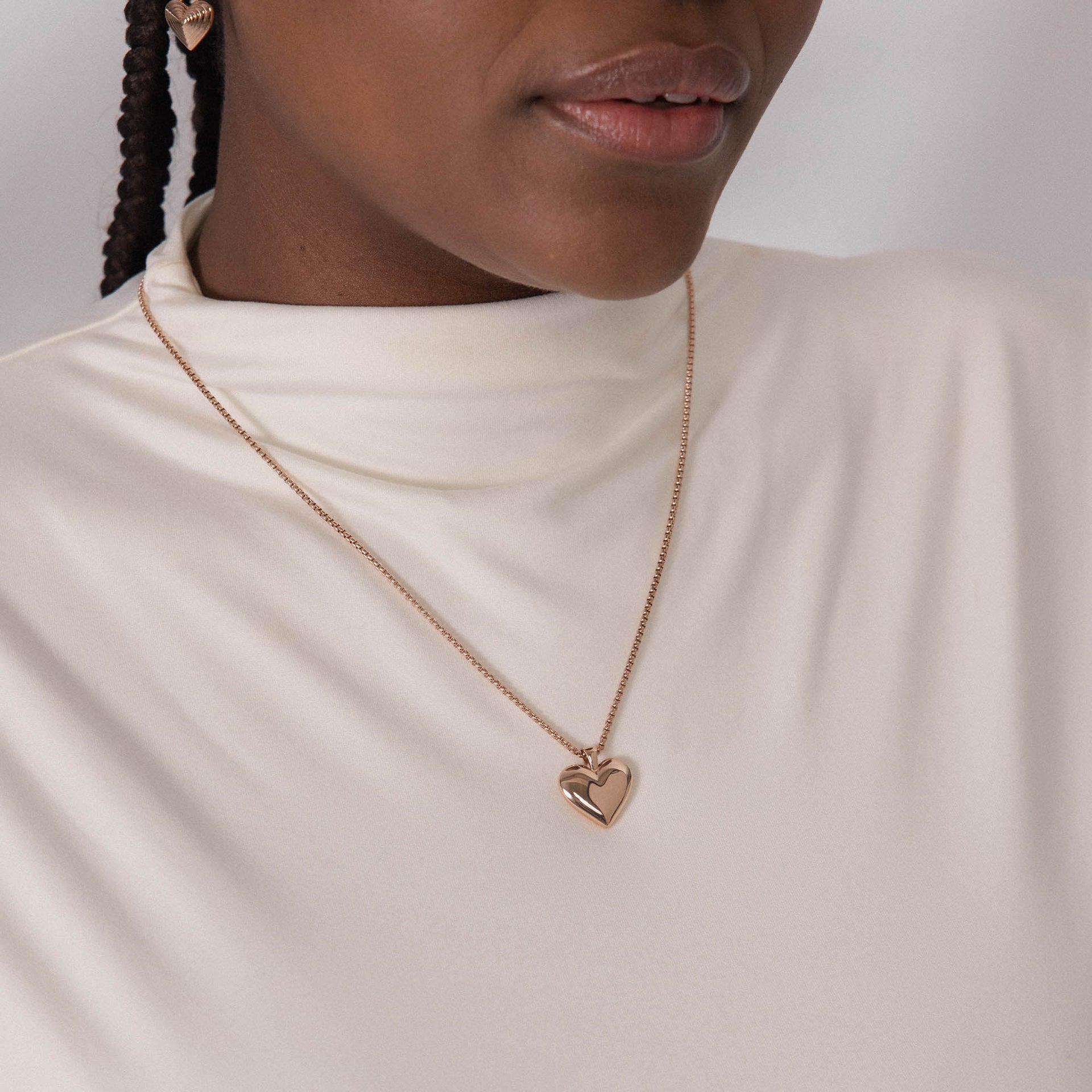 Roségoldene Herz-Halskette von PURELEI, elegant und feminin, getragen auf einem weißen Oberteil.